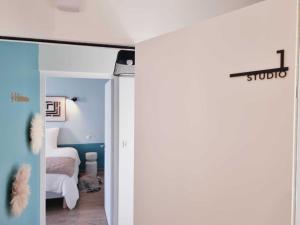 a bedroom with a door open to a bedroom with a bed at La Chauvinière in Montaigu