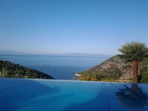 a view of the ocean from a swimming pool at Elies Houses in Agnontas