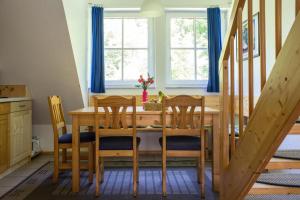 a dining room with a wooden table and chairs at Ferienwohnung Ferienhäuser am Brocken, 80 qm 3 Schlafzimmer in Ilsenburg