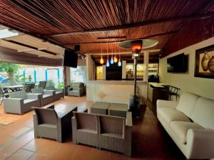a lobby with couches and chairs and a bar at Blue Lantern Bed and Breakfast in Kempton Park