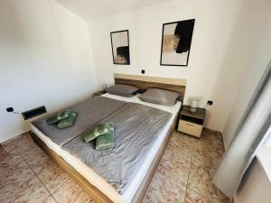 a bedroom with a bed with two pillows on it at Apartment Schwarz in Petrčane V in Gornje Petrčane