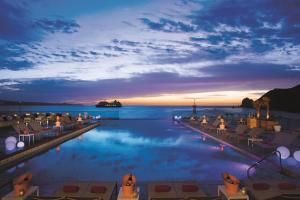 a pool at a resort with a view of the ocean at Breathless Cabo San Lucas - Adults Only in Cabo San Lucas
