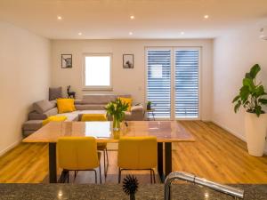a living room with a table and a couch at Schwarzwald Loft Friesenheim in Friesenheim