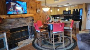 a kitchen and living room with a table and a fireplace at Mountain View Retreats in Gatlinburg