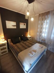 a bedroom with a large bed and two night stands at Guest House ALEJA in Myza Bene