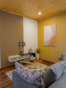 a living room with a couch and a table at Marine Sky Apartment in Maggona West