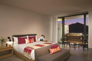 a bedroom with a king sized bed and a balcony at Breathless Cabo San Lucas - Adults Only in Cabo San Lucas