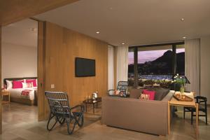 a living room with a couch and a bed at Breathless Cabo San Lucas - Adults Only in Cabo San Lucas