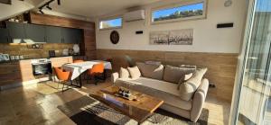 a living room with a couch and a table at Sweet Sea Villa in Utjeha
