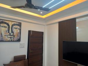 a living room with a ceiling fan and a television at Stay comfort at City Heart 2Bhk AC ,WIFI & Much more in Indore