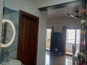 a bathroom with a sink and a mirror at Stay comfort at City Heart 2Bhk AC ,WIFI & Much more in Indore