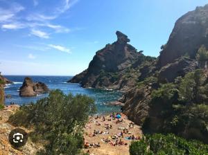 a group of people on a beach near the ocean at Logement indépendant avec parking dans un quartier de standing proche de la plage in Les Lecques +14 photos