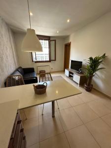 a living room with a couch and a table at Estudio centro in Pontevedra +8 photos
