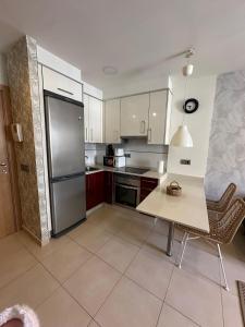 a kitchen with a refrigerator and a table and chairs at Estudio centro in Pontevedra