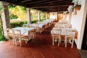 a row of tables and chairs on a patio at Hotel Palumbalza Porto Rotondo in Porto Rotondo