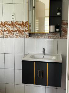 a bathroom with a sink and a mirror at Galaxy Villa room in Dalaguete