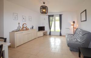 a living room with a couch and a tv at 1 Bedroom Awesome Home In Vignale in Vignale