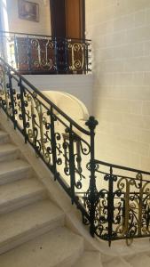 a set of stairs with a wrought iron railing at Château de Puycharnaud in Lacaud