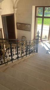 a staircase with a railing in a building at Château de Puycharnaud in Lacaud +86 photos