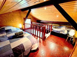 a bedroom with two beds in a log cabin at Maison avec terrasse proche Lyon in Rillieux