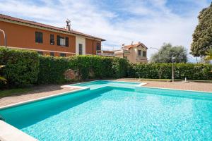 a swimming pool in front of a house at Pool and Relax at Casa Ilenia in Bordighera