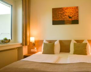 Postel nebo postele na pokoji v ubytování Hotel Am Greiner