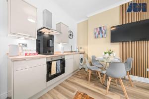 a kitchen and dining room with a table and chairs at 2 Bed Home with Parking Sleeps 4 in Fife