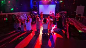 a group of children dancing on the floor in front of a stage at Ferienpark-Canow in Canow +70 photos