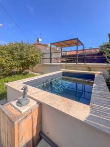 a swimming pool on the side of a house at Le Terra'Ciel - Ciotat in La Ciotat