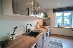 a kitchen with a sink and a counter top at Tiigi Apartment Enjoy City Center Stay with Free Bikes and Self Check-in in Kärdla