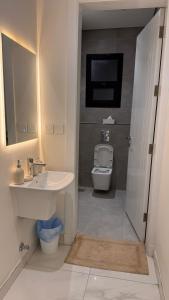 a bathroom with a sink and a toilet at Hotel Apartment - 4 - LAvner Al hussma in Quai