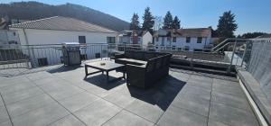 a patio with a table on a balcony at Chill and Thrill in Landstuhl