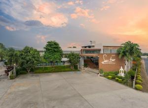 a building with a parking lot in front of it at Sunday Sea Two Pool Villa Pattaya in Jomtien Beach