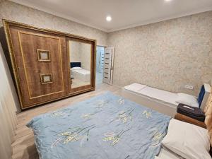 a bedroom with a bed and a large mirror at New Blue Villa VFA in Gabala
