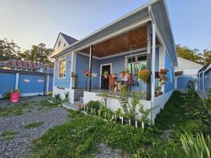 a blue house with a porch with flowers on it at New Blue Villa VFA in Gabala