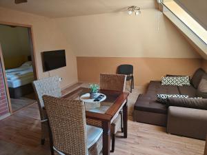 a living room with a couch and a table at Parrot district apartments in Nové Zámky
