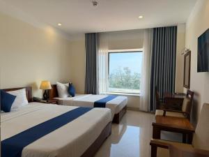 Postel nebo postele na pokoji v ubytování Navy Hotel Cam Ranh