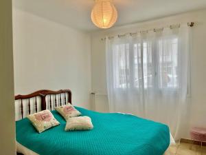 a bedroom with a bed with two pillows on it at Les Bleuets in Cagnes-sur-Mer