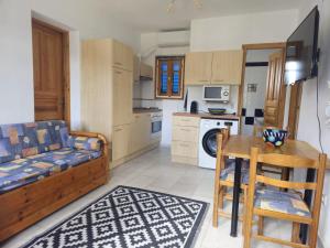 a living room with a couch and a table in a kitchen at Paros Molos beachfront appartment in Kampos Paros