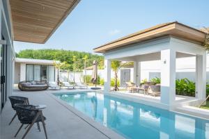 an image of a swimming pool in a house at Mouana Breeze Mai Khao VIP 4-bedroom Pool Villa 9911 in Phuket