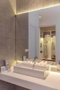 a bathroom with a white sink and a mirror at Lindia Athena Luxury Villas in Líndos