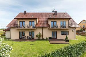 a large house with a large yard in front of it at Tasarz 2 in Rewal