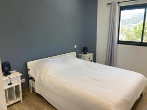 - une chambre avec un lit blanc et une fenêtre dans l'établissement Cap Sud,apt 4p,vue mer,pr plage, au Lavandou