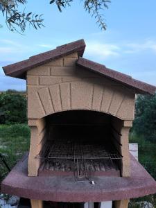 a brick oven with a grill inside of it at Casa dei Mori oasi di pace in San Corrado di Fuori