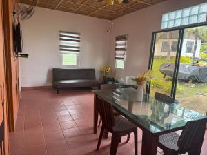 a dining room with a table and a couch at Galaxy Family Room in Dalaguete