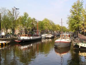 a group of boats are docked in a canal at B&B La Festa in Amsterdam