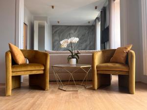 a living room with two chairs and a couch at Luxury Suite Monti Quirinale in Rome