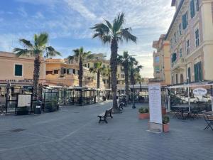 a town square with palm trees and buildings at Casa Leone vicino al mare in Lido di Ostia