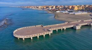 an aerial view of a pier in the water at Casa Leone vicino al mare in Lido di Ostia +4 photos