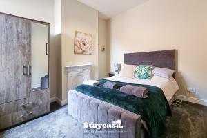 a bedroom with a large bed and a mirror at Clarence Co-living - Private Room Self-cater in Manchester